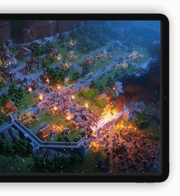 Rise of Kingdoms official tablet-device mockup showing an aerial nighttime city-siege battle scene from the game